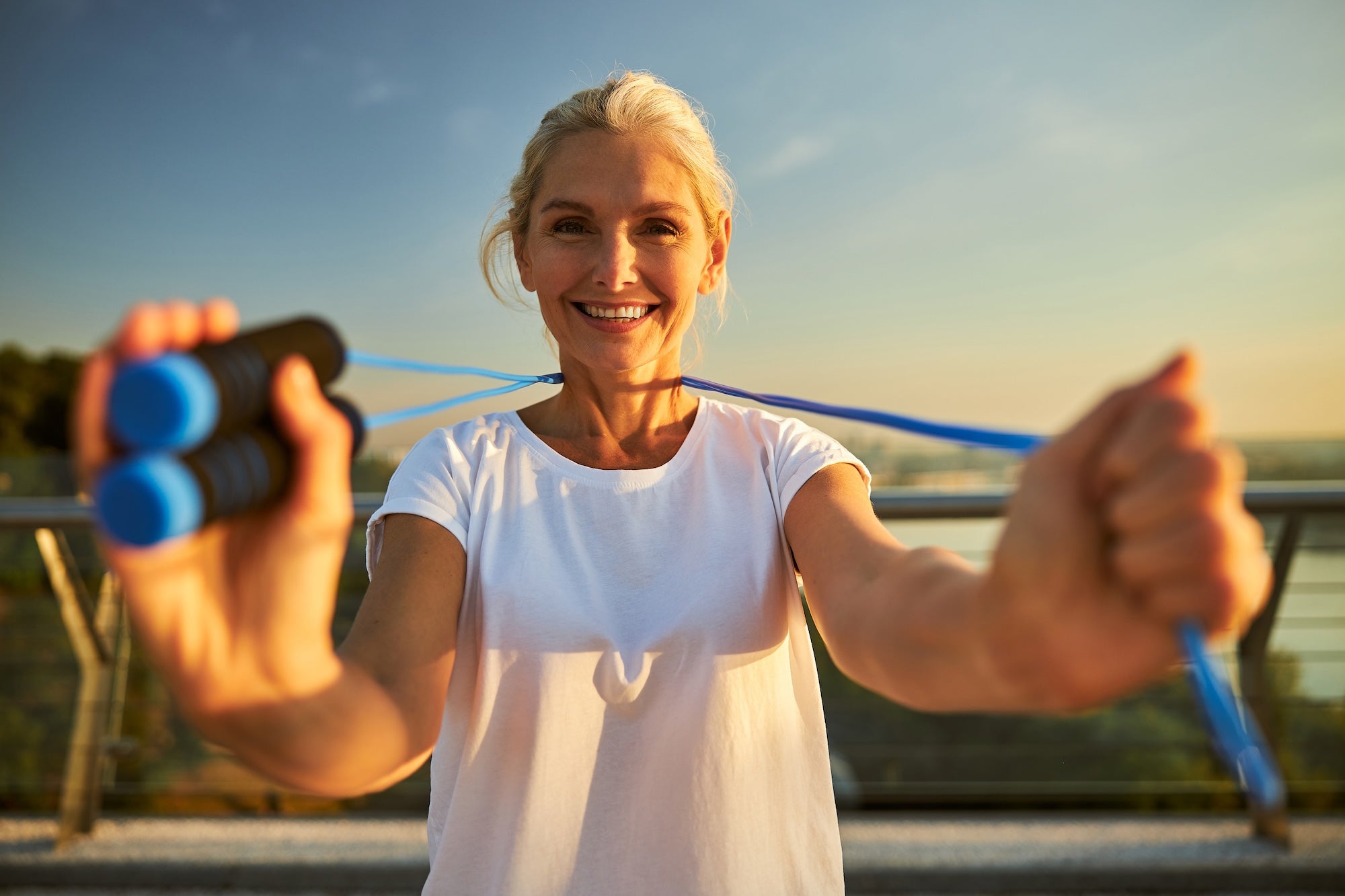 Active woman over 40 skipping rope outdoors — HDAA amino acid supplements supporting energy, hydration and recover