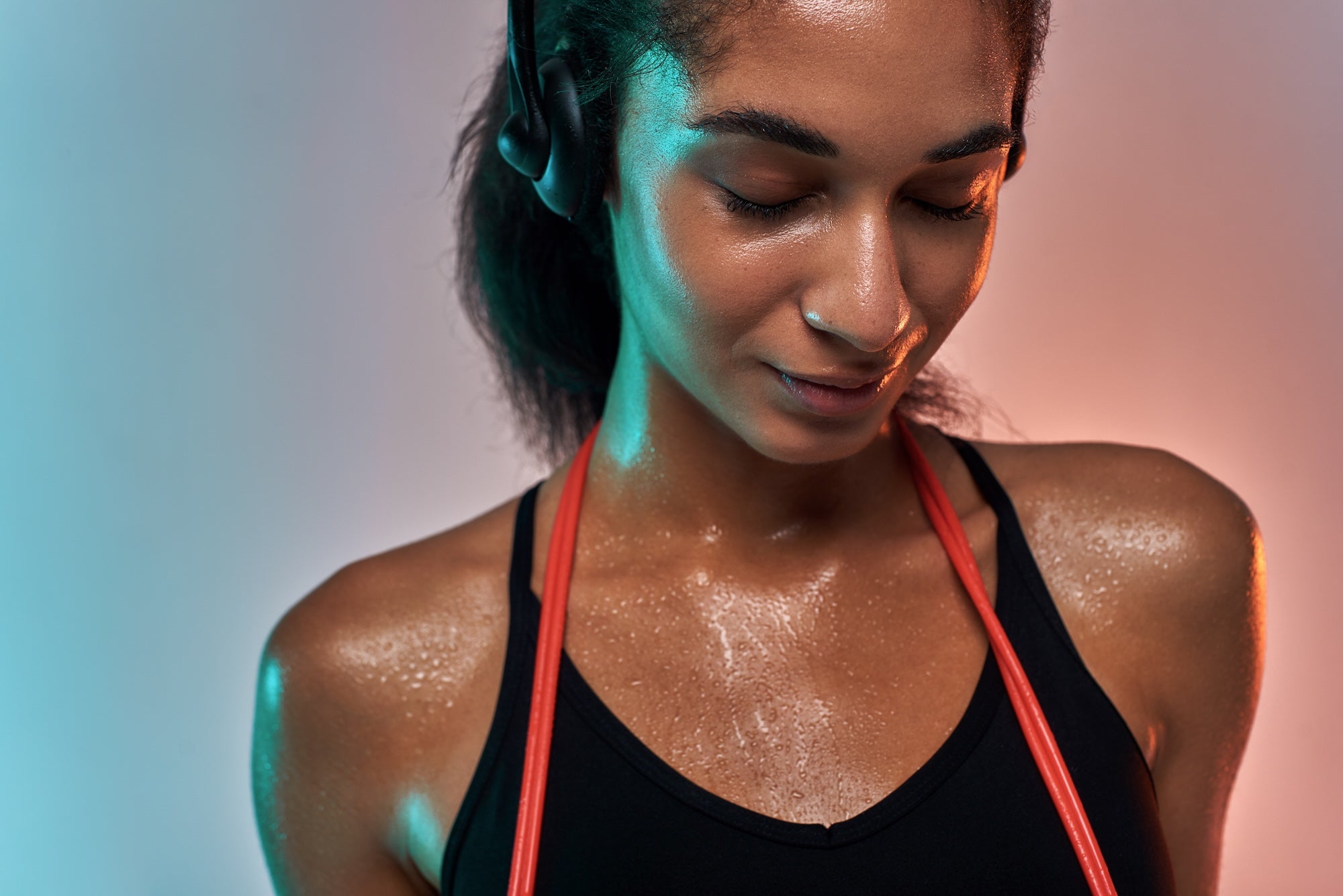 Woman in athletic wear with glowing effects on a gradient background